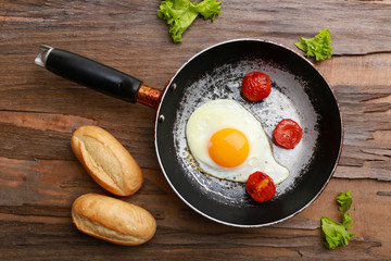 Bacon and eggs on rustic wooden planks background