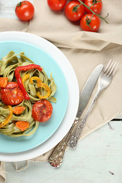 Tasty pasta with pepper, carrot and tomatoes