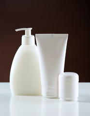 Group of cosmetic bottles on dark background