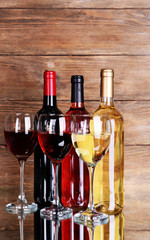 Different wine on table on wooden background