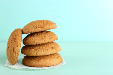 Tasty cookies on color wooden background