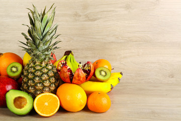Assortment of exotic fruits on wooden background