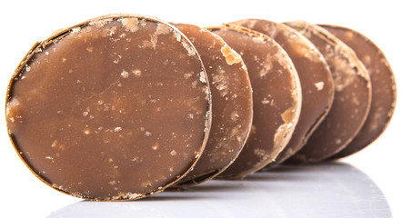 Round palm sugar over white background