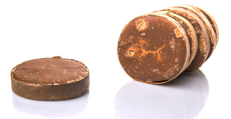 Round palm sugar over white background