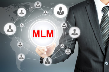 Businessman hand pointing on MLM (Multi Level Marketing) sign 