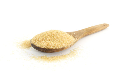 Heap of  brown sugar on wooden against white