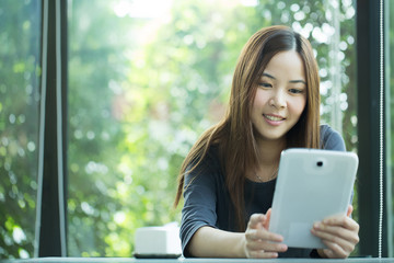 Young Asian girl use tablet for search information