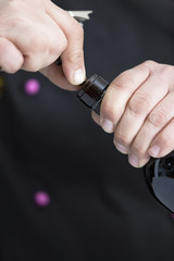 Fototapeta premium uncorking a bottle of red wine.