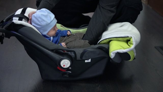 Putting baby in seat and protecting from falling out