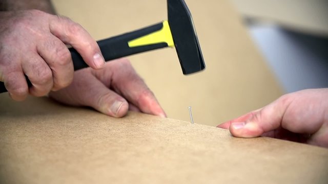Detail of hammering down small nails