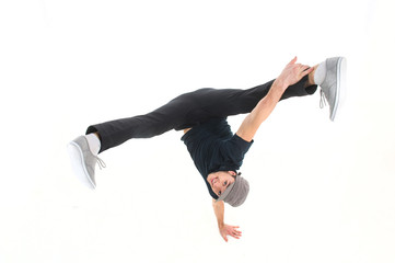 young dancer standing on hand on white background in studio.