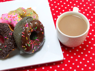 donut and milk coffee on red tablecloth