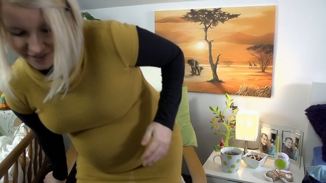 Expectant mother stands up and walks past camera