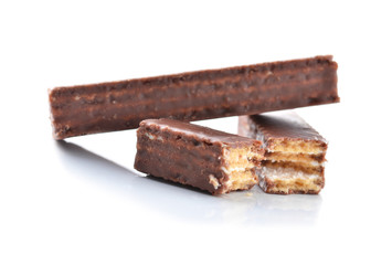 Broken milk chocolate bar isolated on white background