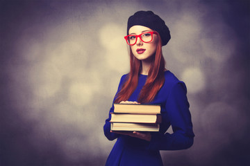girl in blue dress with books