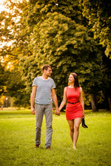 Fototapeta premium Young couple walking on grass