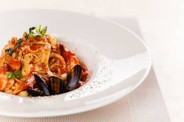 Spaghetti with tomato sauce and basil on plate.