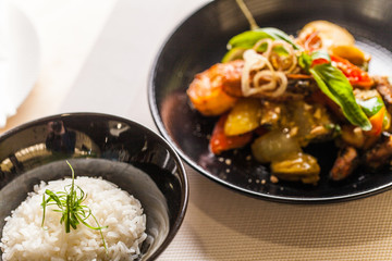 closeup on black plate with hot food.