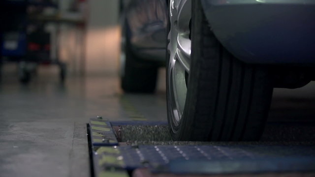 Detail shot of testing the rear tires on the automobile