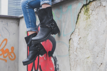 Detail of a young woman wearing biker boots