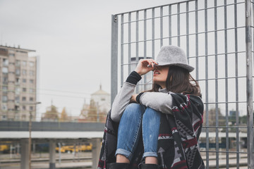 Beautiful young brunette posing in the city streets