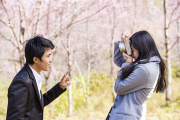 Fototapeta premium Man and girl photographer outdoors holding vintage camera.