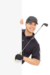 Male golfer posing behind a blank panel