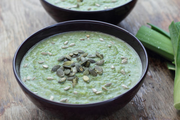 Closeup of pureed leek soup with sunflower and pumpkin seeds.
