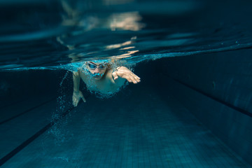 Male swimmer at the swimming pool.Underwater photo.
