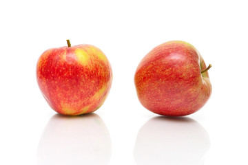 Two ripe red apple on a white background close-up