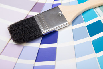 interior design - paint brush over colorful palette with vivid c
