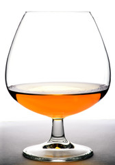 Glass with cognac on white background