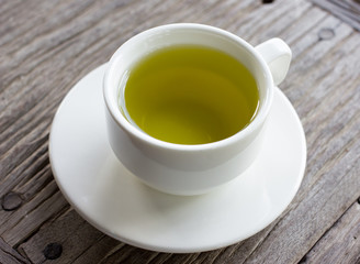 Hot green tea on wood table.
