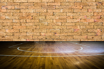wooden floor basketball court with red brick wall texture backgr