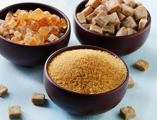 Brown sugar  in clay bowls .