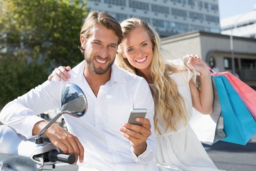 Attractive couple riding a scooter