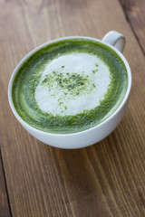 Matcha green tea latte beverage in glass.