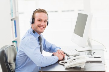 Obraz na płótnie Canvas Smiling businessman speaking with headset