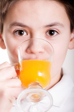 Boy drinks the orange juice