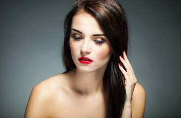 Natural woman face with red lips, nails and long hair