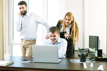 Young business people discuss the new project at office