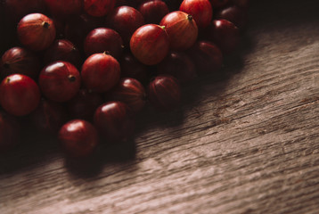 Red gooseberries on wooden background