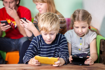 Family activities for game on smartphones, all sit with gadgets