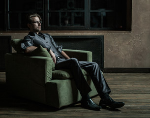 Businessman sitting on an armchair