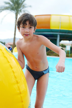 preteen little boy in open air aqua park