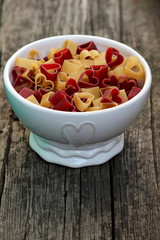 Heart-shaped pasta on the wooden table