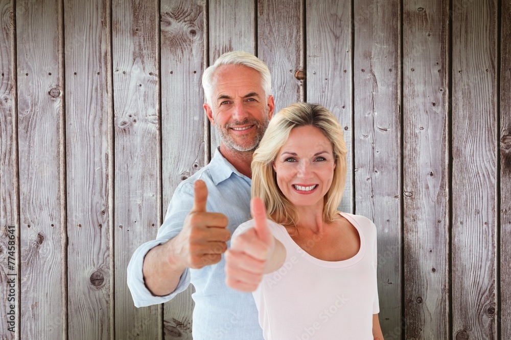 Poster composite image of smiling couple showing thumbs up together