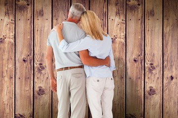 Fototapeta premium Composite image of happy couple standing and looking