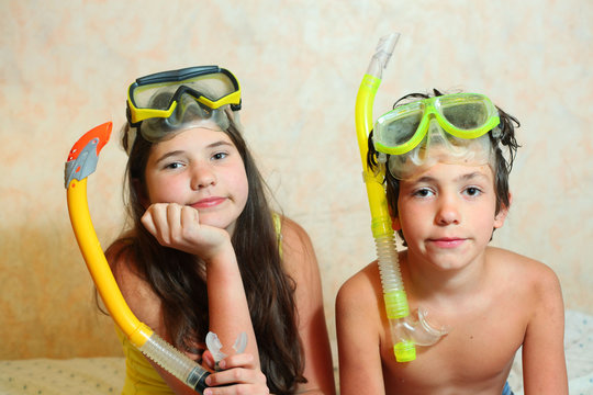 preteen siblings boy and girl in snorkeling mask and tube