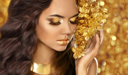 Fashion Beauty Girl Portrait. Eyes makeup. Golden jewelry. Attra